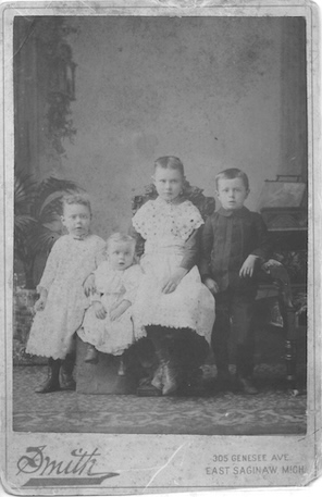 Black and white portrait of four children from about 1890.
