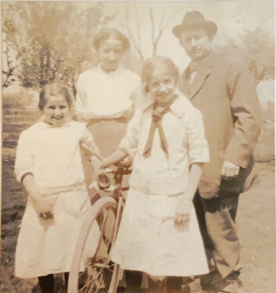 Sepia-toned photo of a Saginaw, Michigan, family around 1917 or 1918. The Stielow family from left, Arvilla, Minnie, Etta and Herman. By February 1917, Herman and Minnie Stielow had lost their sixth child in a row. They lost a seventh in July 1918. Johnson family photo; photographer unknown.